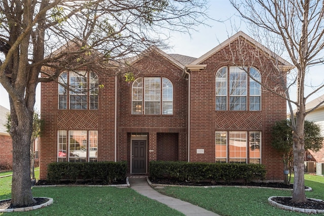 view of front of property featuring a front yard and central AC unit