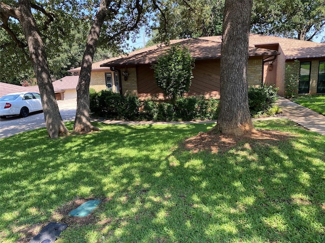 view of front of property with a front yard and brick siding