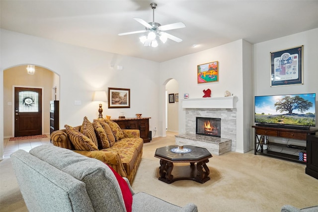 carpeted living room featuring ceiling fan