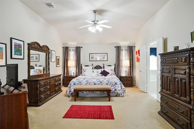 carpeted bedroom featuring ensuite bath, vaulted ceiling, and ceiling fan