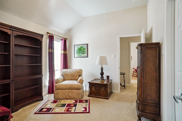 sitting room with lofted ceiling and light carpet