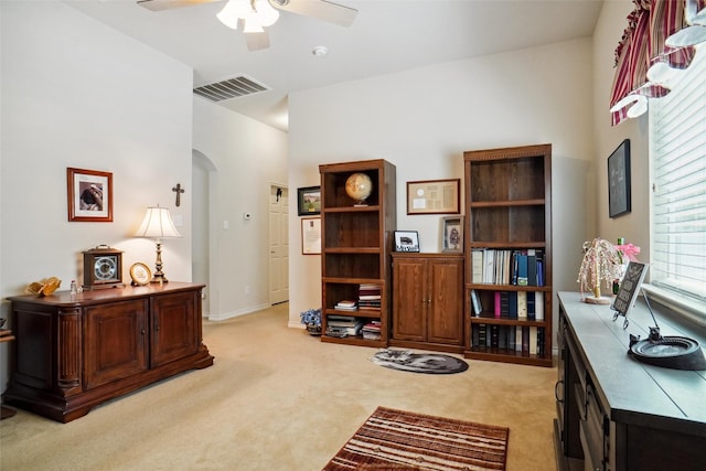 carpeted home office featuring ceiling fan