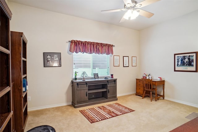 carpeted home office featuring ceiling fan