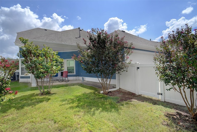 exterior space featuring cooling unit, a patio area, and a lawn