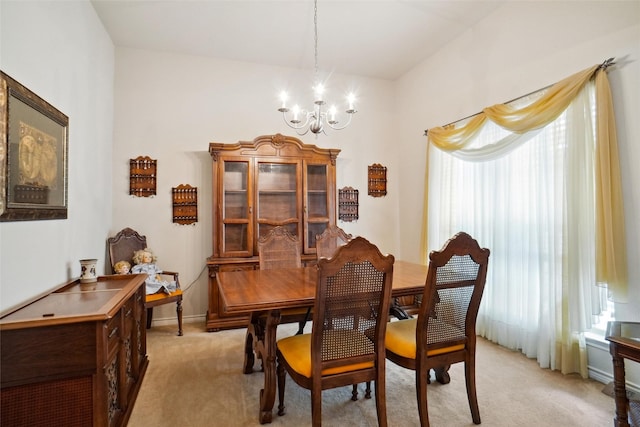 carpeted dining room with an inviting chandelier