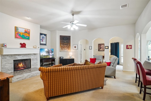 carpeted living room featuring ceiling fan