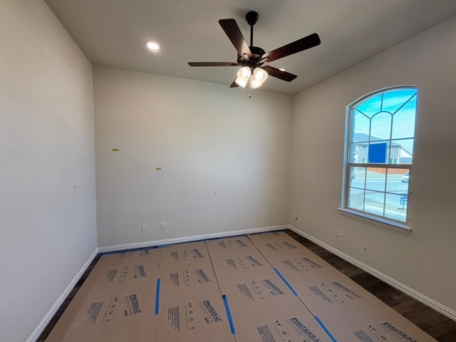 spare room with recessed lighting, a ceiling fan, baseboards, and wood finished floors