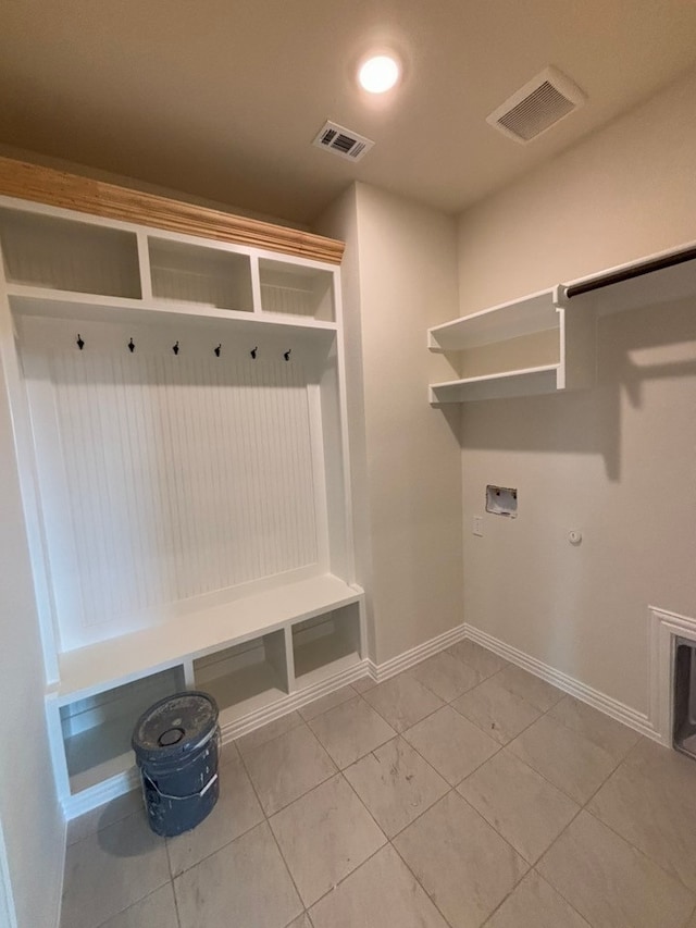 mudroom with light tile patterned floors, visible vents, and baseboards