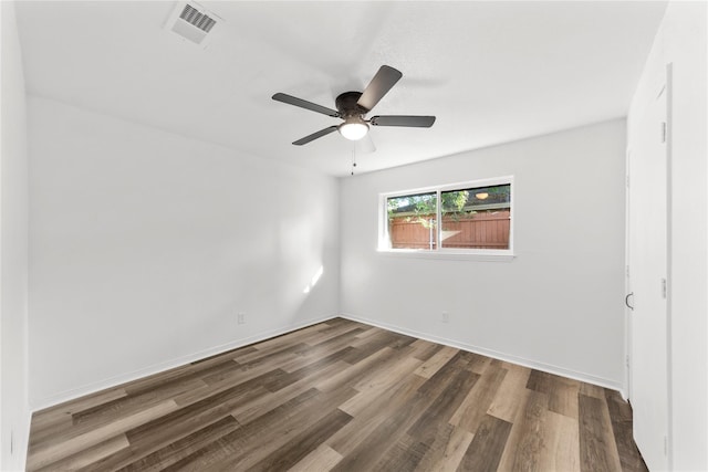 spare room featuring ceiling fan and dark hardwood / wood-style flooring