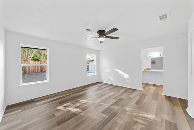 empty room with ceiling fan and light wood-type flooring