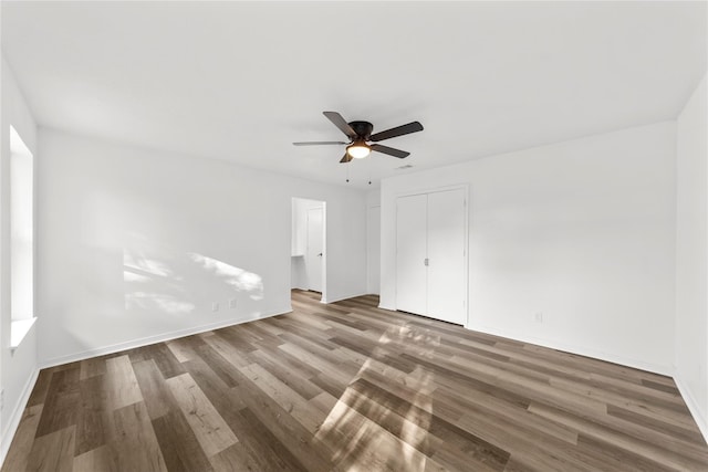 empty room with wood-type flooring and ceiling fan