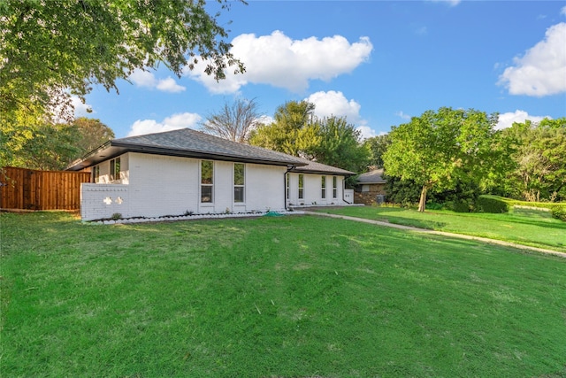 rear view of property with a yard