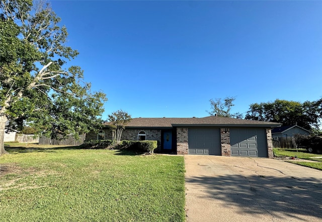 view of front facade featuring brick siding, an attached garage, fence, a front yard, and driveway