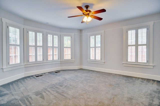 empty room featuring carpet floors and ceiling fan