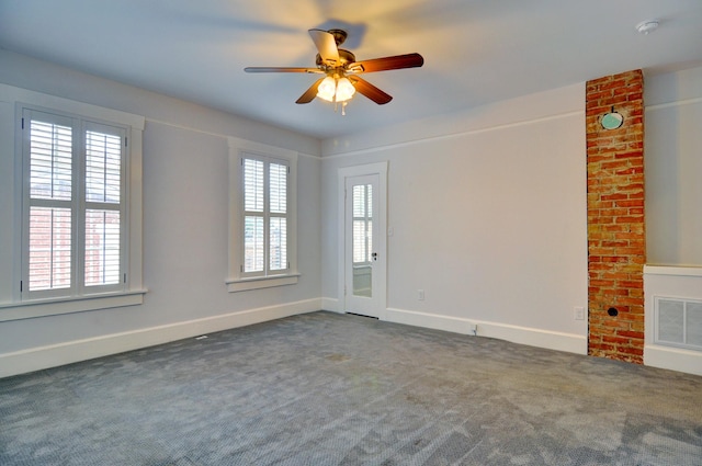 carpeted spare room featuring ceiling fan