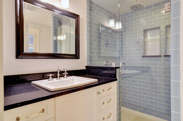 bathroom featuring vanity and a shower with shower door