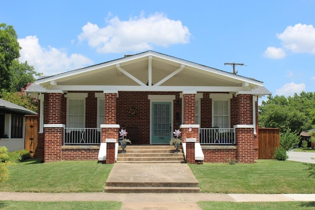 bungalow-style house with covered porch and a front lawn