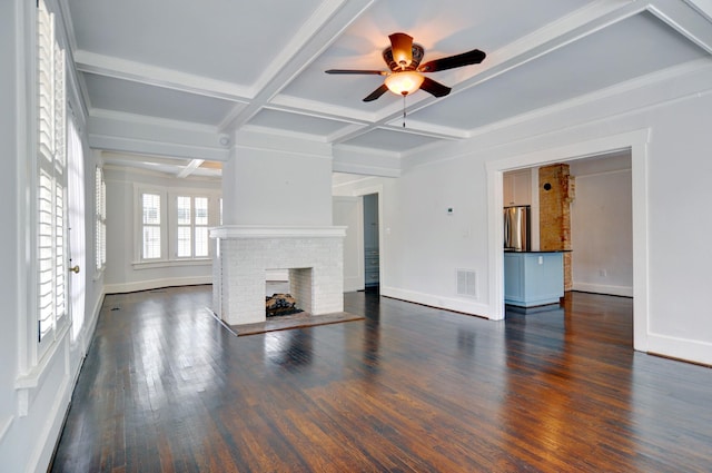 unfurnished living room with coffered ceiling, a brick fireplace, dark hardwood / wood-style flooring, ceiling fan, and beam ceiling