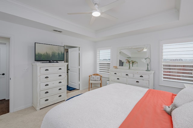 bedroom featuring visible vents, a raised ceiling, and ornamental molding