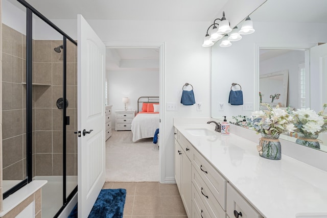 ensuite bathroom with a shower stall, vanity, connected bathroom, and tile patterned floors