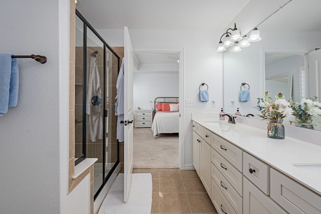 ensuite bathroom with double vanity, tile patterned floors, ensuite bath, and a shower stall