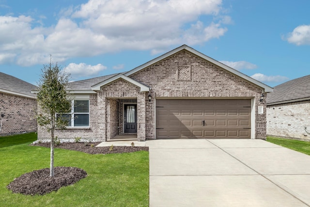 view of front of property featuring a garage and a front lawn