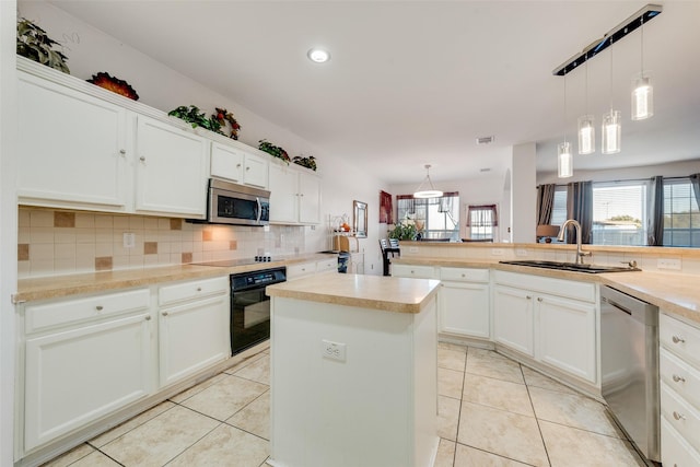 kitchen featuring sink, hanging light fixtures, black appliances, white cabinets, and kitchen peninsula