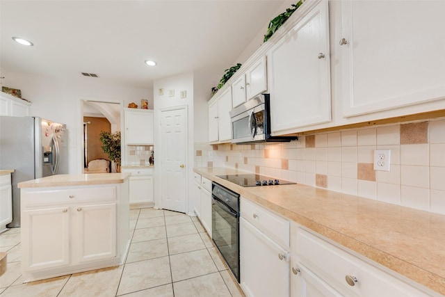 kitchen featuring backsplash, black appliances, white cabinets, and light tile patterned floors