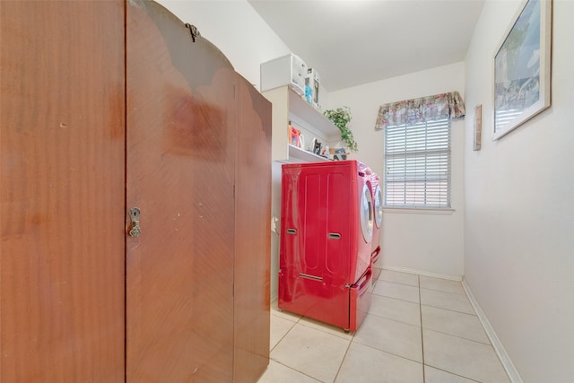 laundry area with washer and dryer and light tile patterned floors