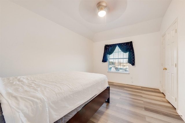 bedroom with lofted ceiling, ceiling fan, and light hardwood / wood-style flooring