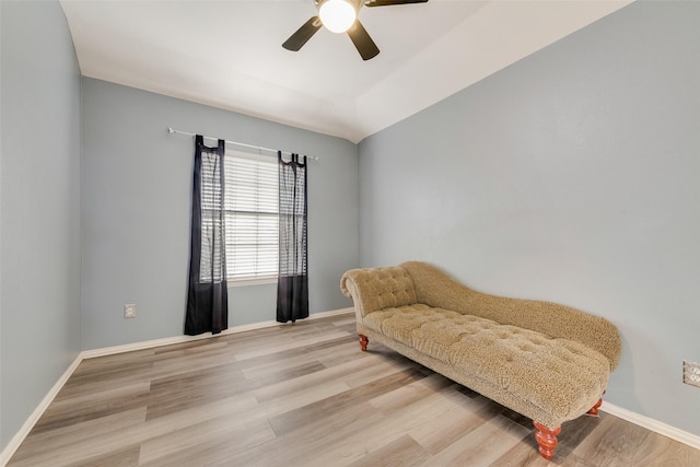 sitting room with ceiling fan, light hardwood / wood-style flooring, and lofted ceiling