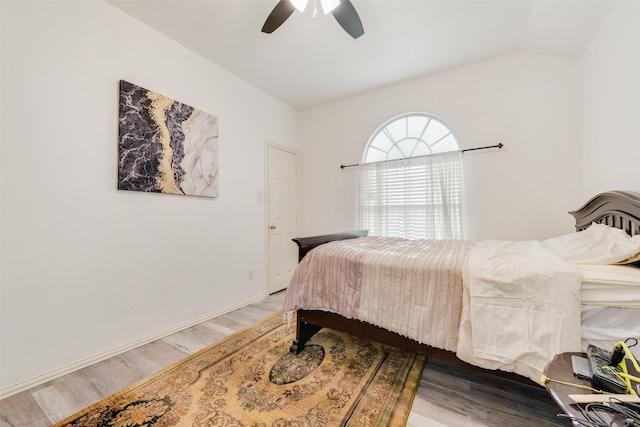 bedroom featuring lofted ceiling, ceiling fan, and light hardwood / wood-style flooring