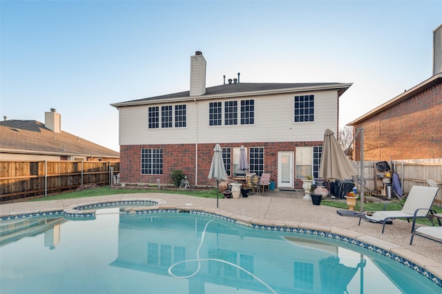 view of swimming pool featuring an in ground hot tub and a patio area