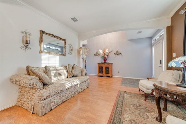 living room featuring light hardwood / wood-style flooring and crown molding