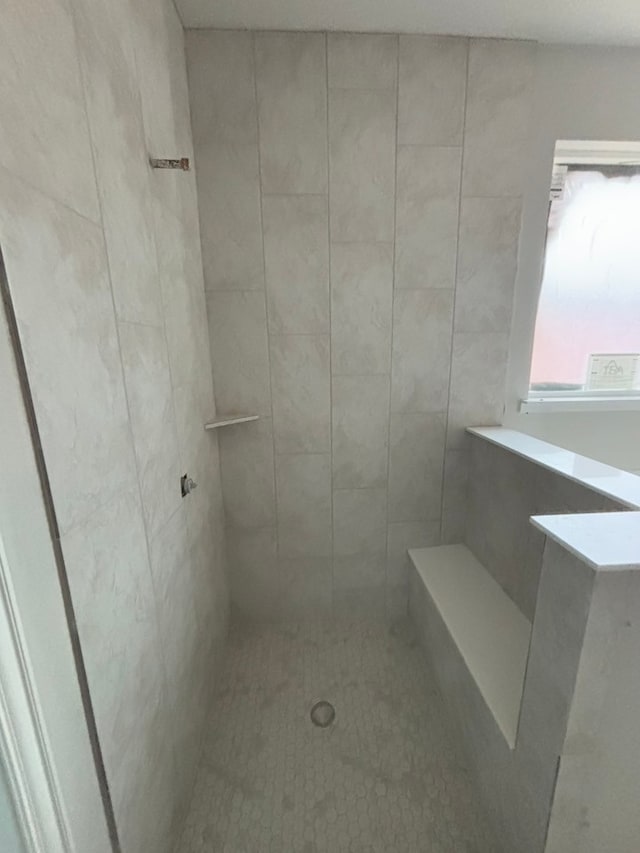 full bath featuring tiled shower