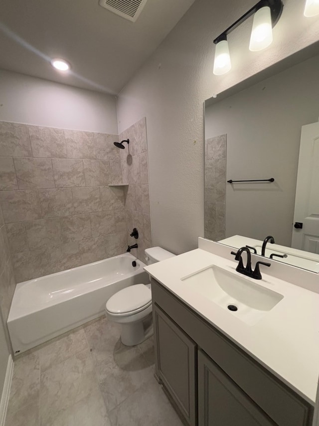 bathroom with visible vents, toilet, vanity, and washtub / shower combination