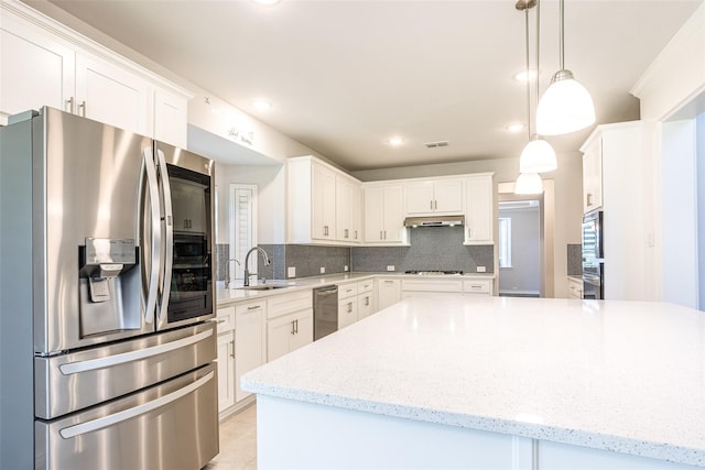 kitchen featuring pendant lighting, white cabinetry, tasteful backsplash, and stainless steel appliances