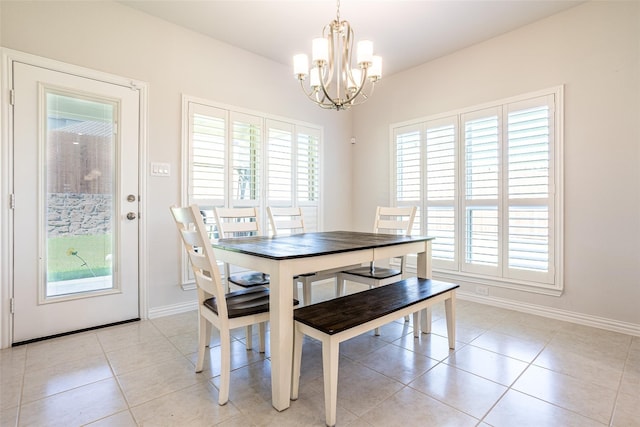 tiled dining area with an inviting chandelier