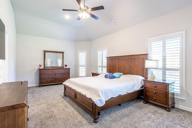 bedroom with vaulted ceiling, ceiling fan, and light colored carpet