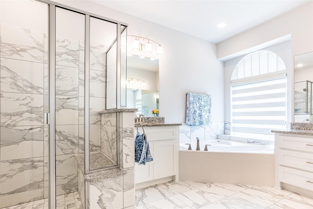 bathroom featuring vanity and shower with separate bathtub