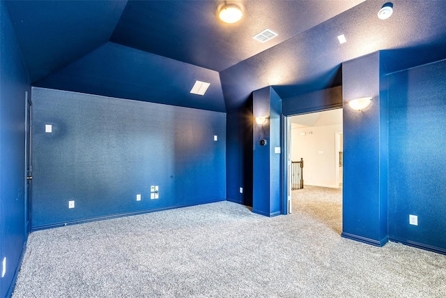 carpeted home theater with lofted ceiling