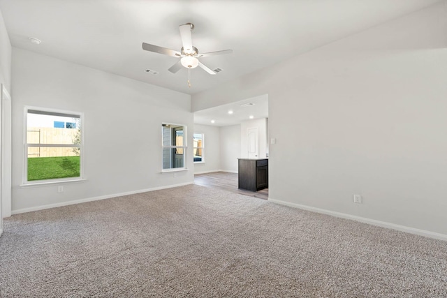 unfurnished living room featuring ceiling fan and light carpet