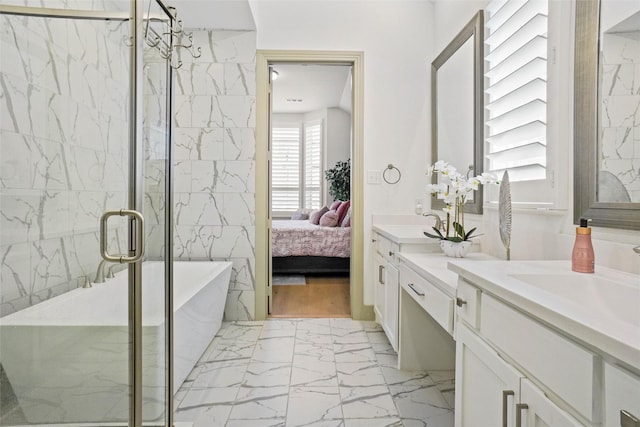 bathroom featuring independent shower and bath and vanity