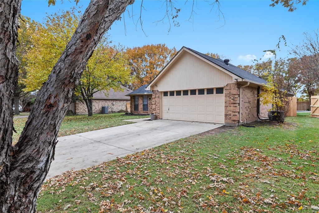 ranch-style home featuring a garage and a front yard