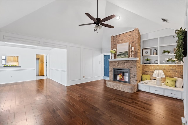 unfurnished living room featuring ceiling fan, high vaulted ceiling, dark hardwood / wood-style flooring, a brick fireplace, and built in shelves