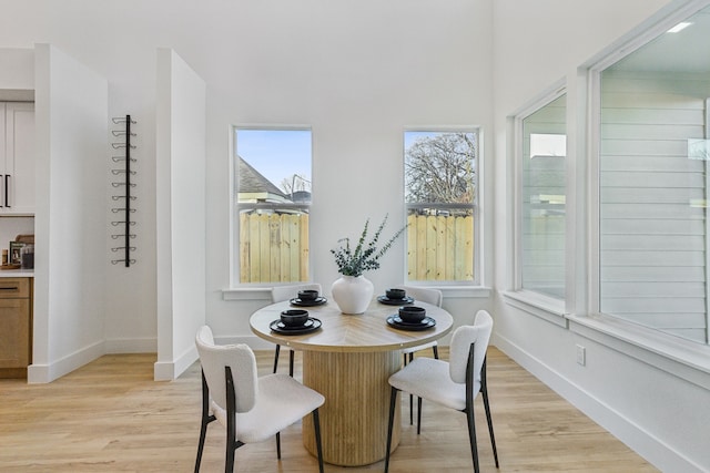 dining space with a healthy amount of sunlight and light hardwood / wood-style flooring