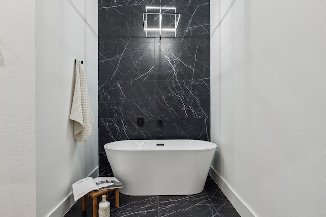 bathroom with a tub and tile walls