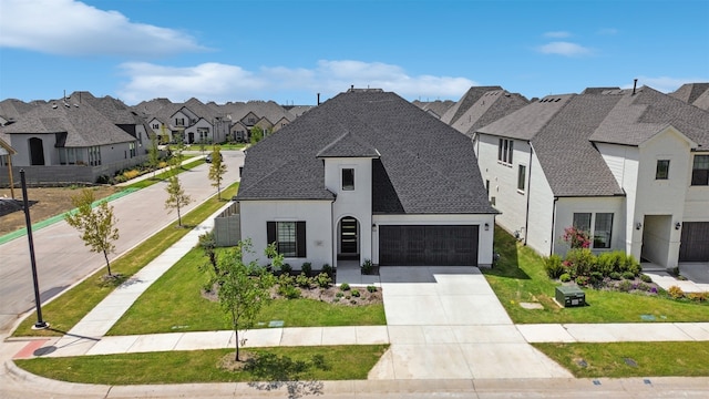 french provincial home featuring a garage and a front yard