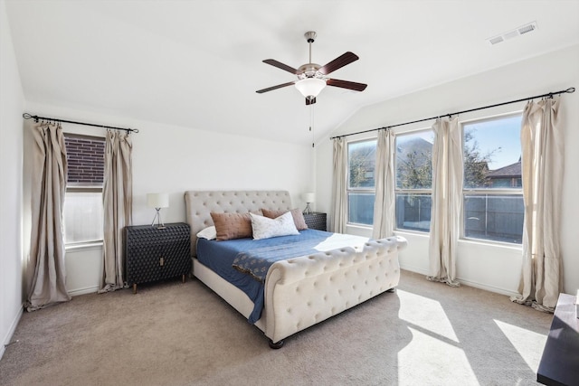 bedroom featuring lofted ceiling, light colored carpet, and ceiling fan