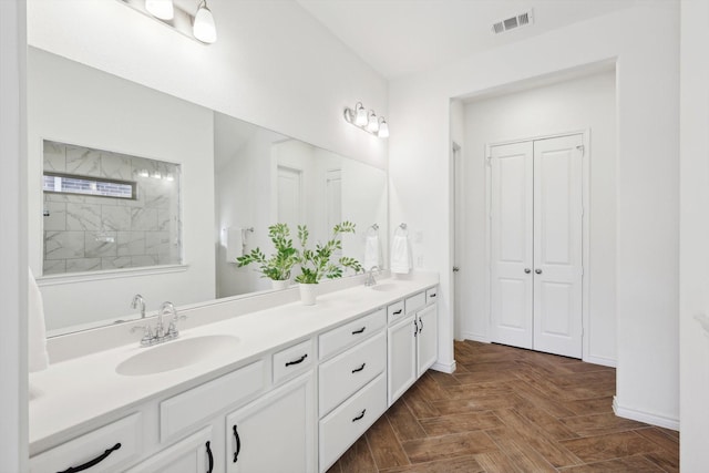 bathroom with vanity, parquet flooring, and a shower